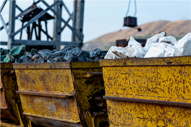 How are mining trucks used for hauling heavy loads in mining operations?