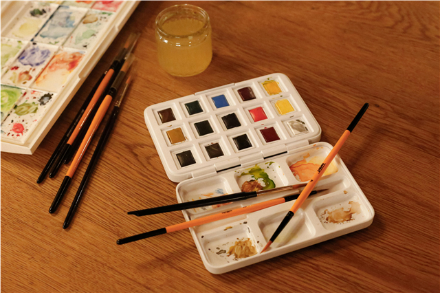 How are rubber stamps used for stamping designs on paper and fabric?