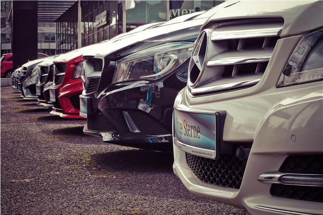 How do luxury cars contribute to eco-friendly driving with hybrid models?